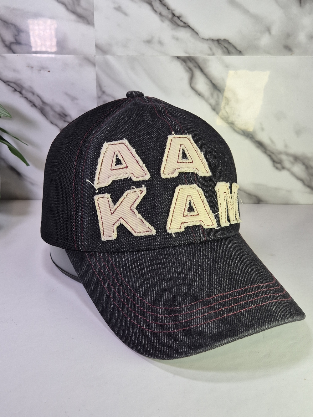 AAKAM Black Denim Baseball Cap with Cream Lettering. Adjustable